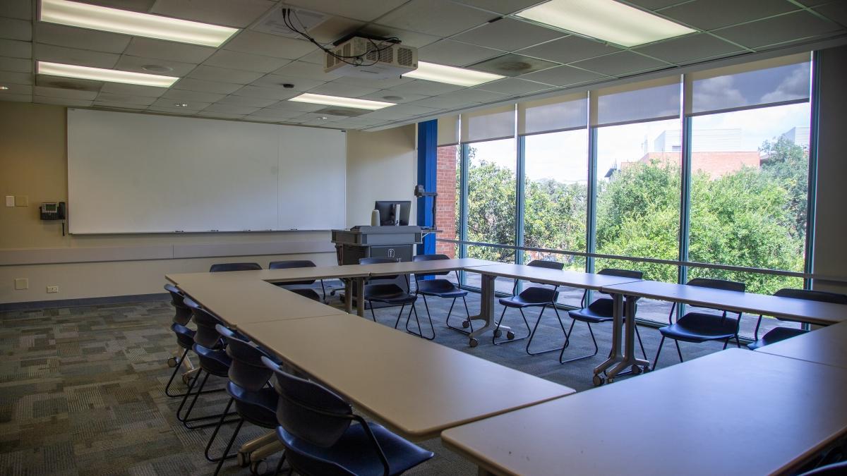 Room set up with desks arranged together 