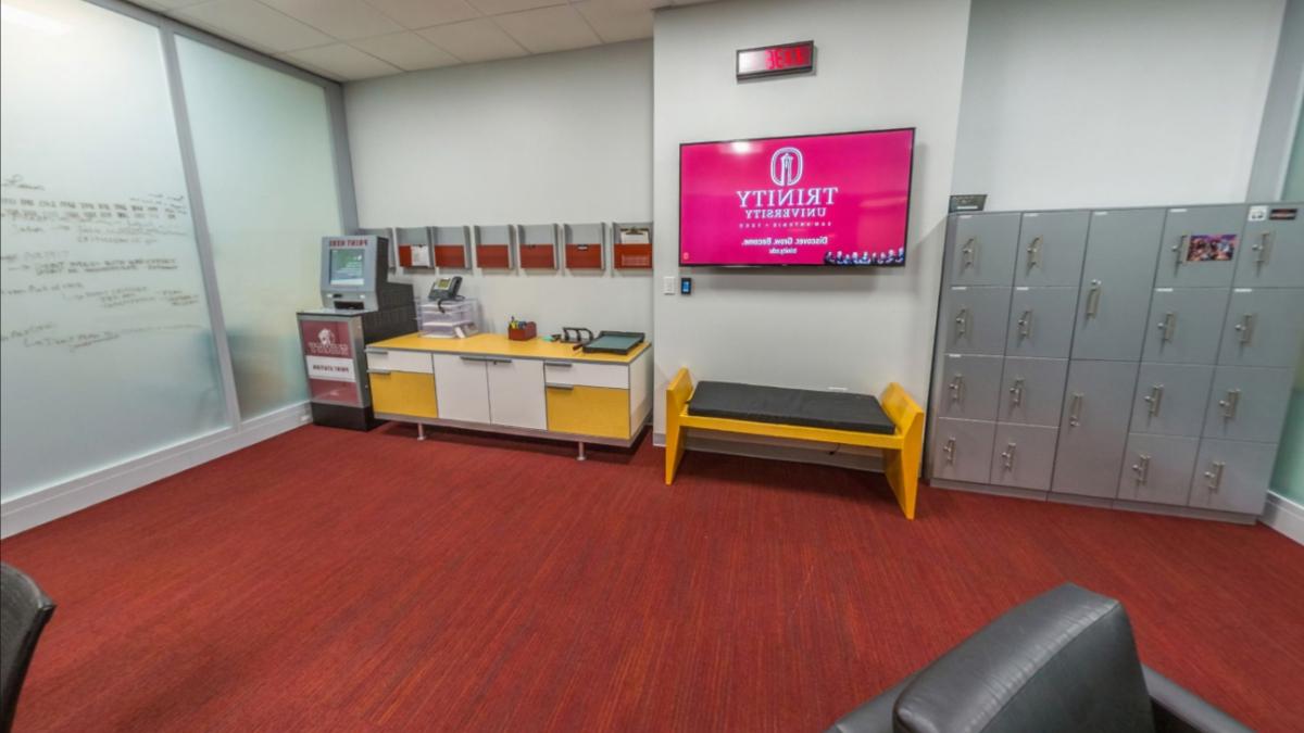 Lockers, a television and workstation set up in the communication studio.